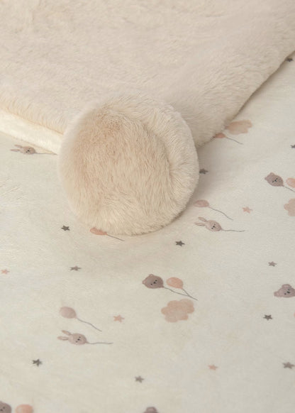 Manta com pompons para bebé